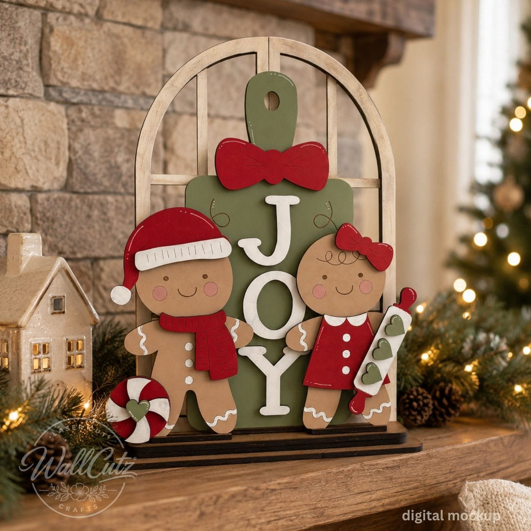 Christmas Cookie Crew wood window kit with painted gingerbread boy and girl beside a green JOY sign – WallCutz